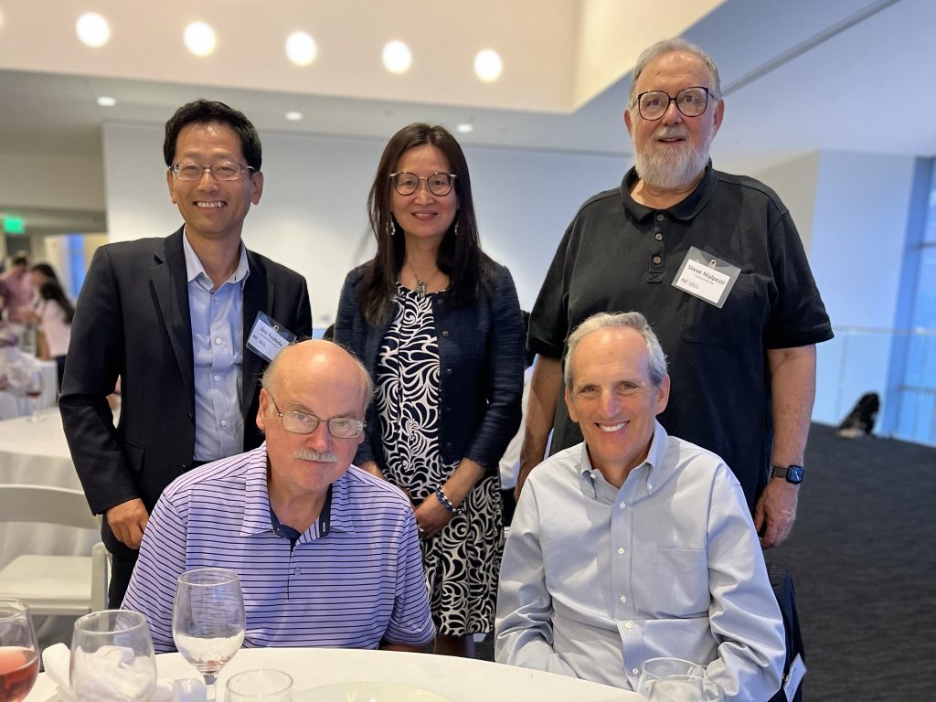 symposium presenters and keynotes pose for picture during reception