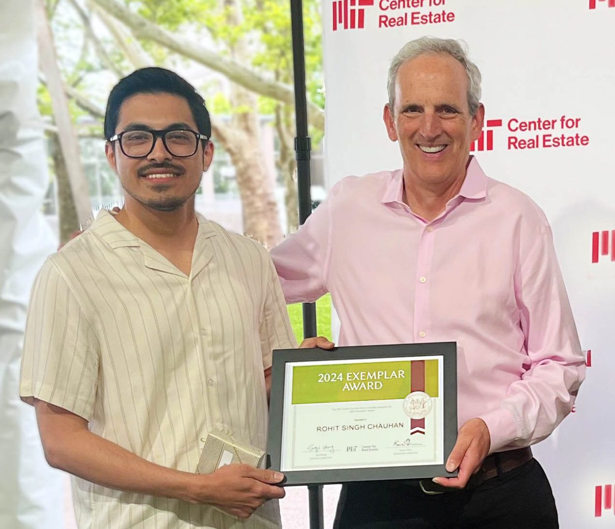 Rohit holds poses with Exemplar Award with Jacques gordon